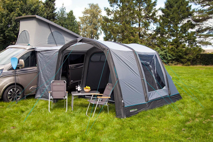 Rear angled view of the Outdoor Revolution Cayman Air T3 Lite driveaway awning connected to a campervan on a grassy campsite.