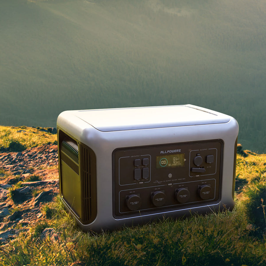 ALLPOWERS R3500 portable power station placed on grassy mountain terrain during outdoor camping.