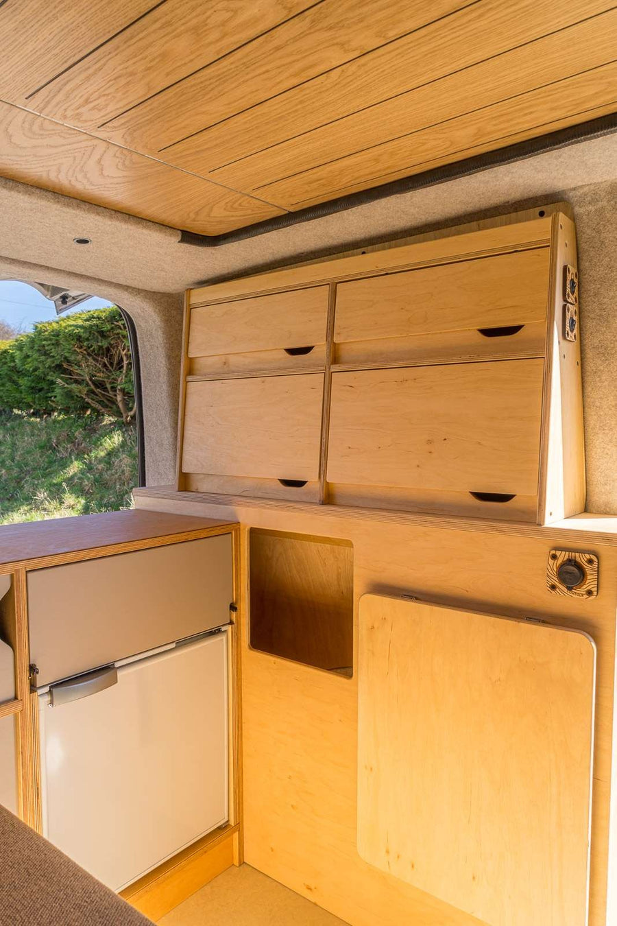 The Campervan Bereau Sideboard includes upper drawer storage and a built-in fridge compartment below, combining practical kitchen space with organised cabinetry.