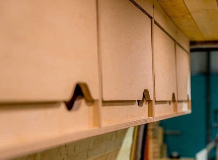 Close-up detail of the Campervan Cornice Top Cabinets front panel showing the curved finger-pull handle design.