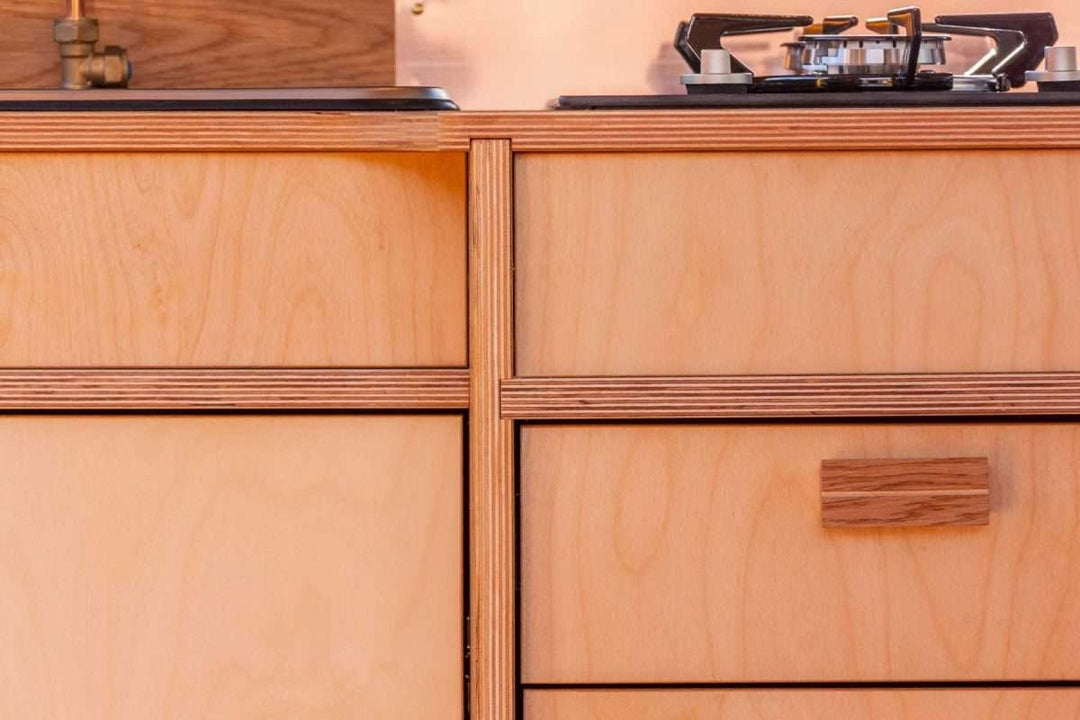 Close-up view of the Campervan Foss Kitchen Unit cabinet front showing the wooden drawers, cupboard doors, and integrated handle design.