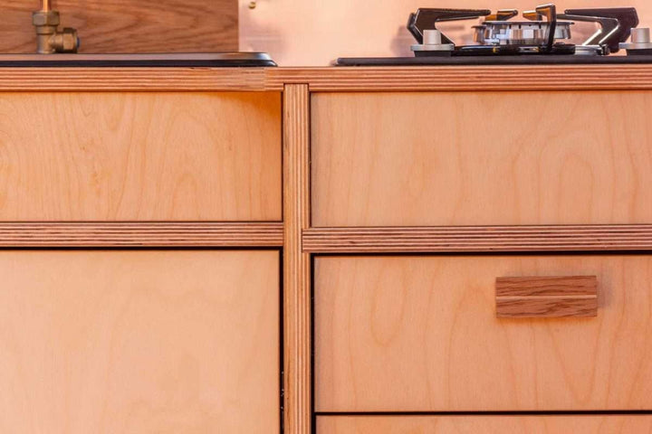 Close-up view of the Campervan Foss Kitchen Unit cabinet front showing the wooden drawers, cupboard doors, and integrated handle design.