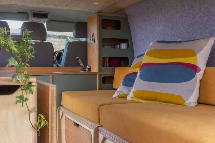 Campervan Navi Kitchen Unit bench seat with mustard cushions and under seat storage compartment.