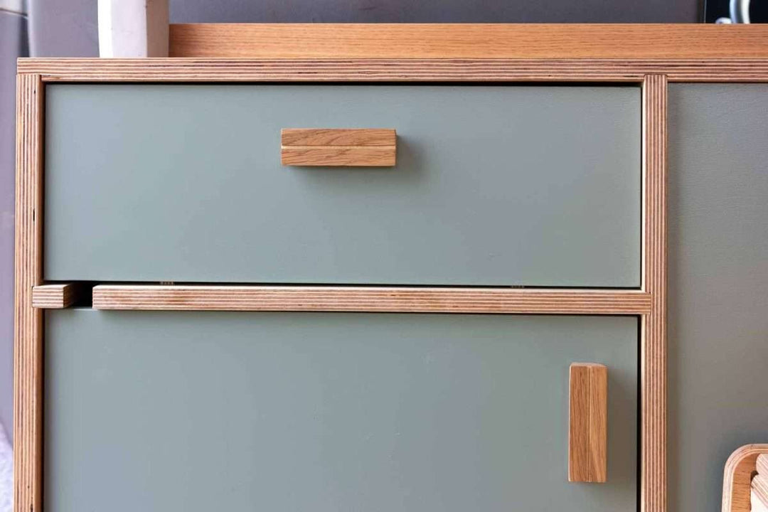 Campervan Navi Kitchen Unit drawer and cupboard detail with soft green front and oak handle finish.
