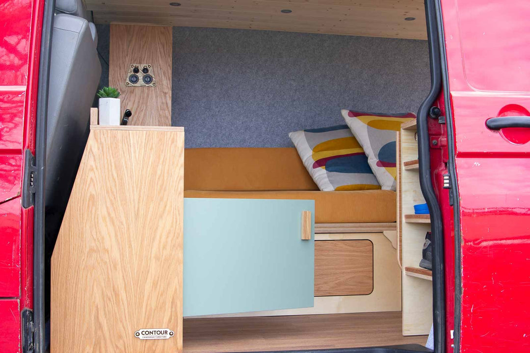Campervan Navi Kitchen Unit compact sofa layout with side cupboard and soft furnishings installed.