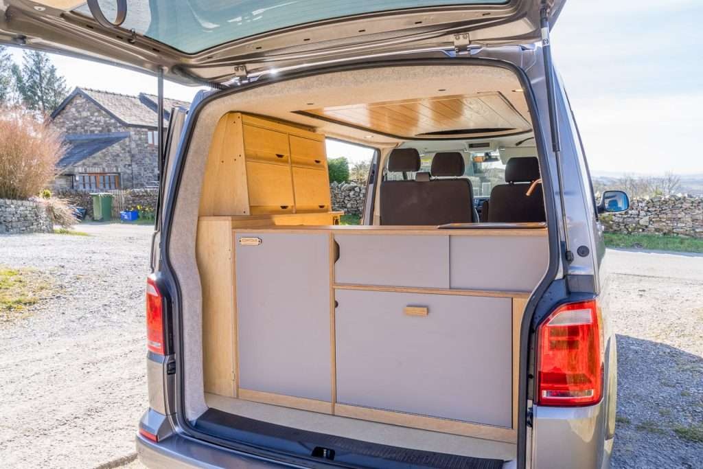 Campervan Ranger Kitchen Unit rear cabinet system installed inside silver campervan with overhead storage.