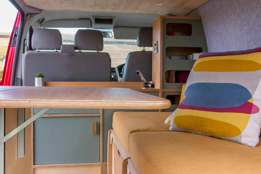 This image presents the Campervan Rig Sideboard with the bed base retracted, highlighting the open floor space and streamlined cabinet design.