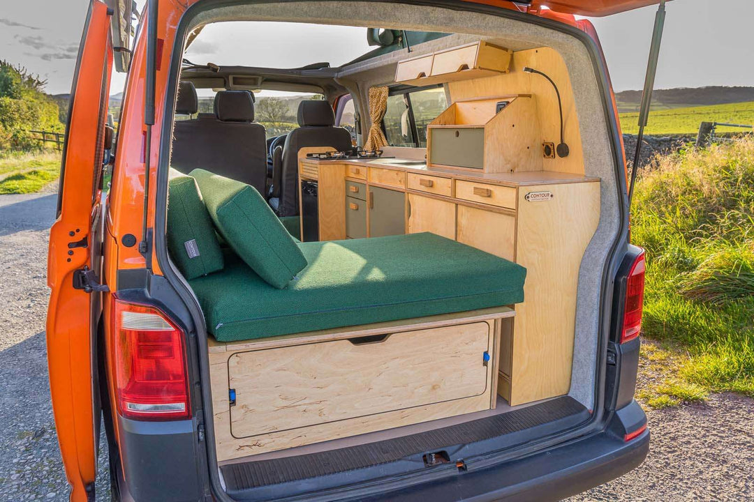 Campervan Squall Kitchen Unit side storage and cooler compartment inside campervan, rural landscape outside.
