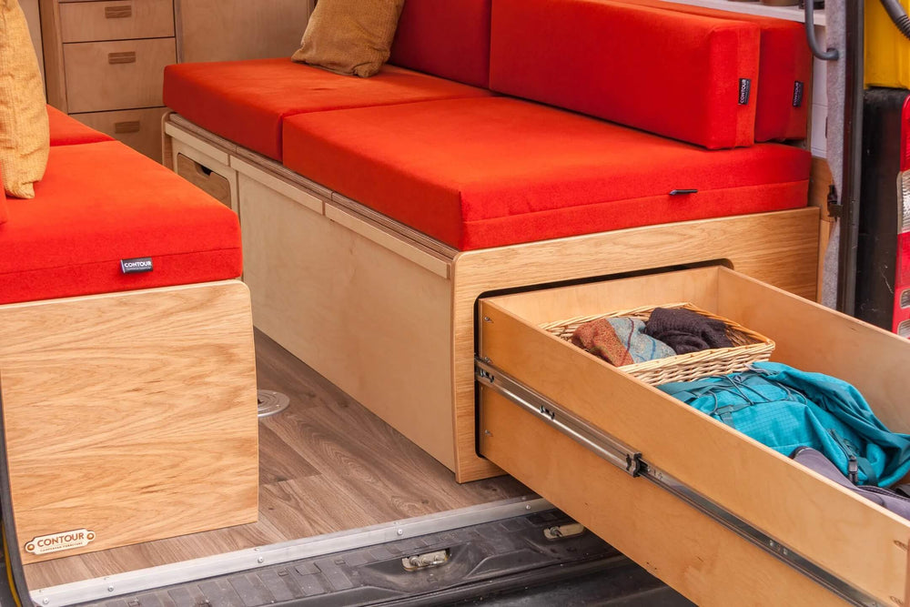 Campervan “Swale” Benches red bench seating with integrated under-seat storage compartment inside yellow campervan.