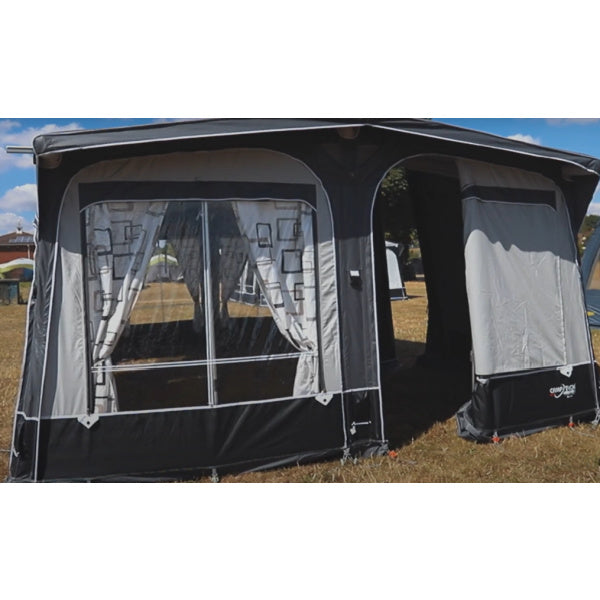 Camptech Duke Awning shown from the front in a field with an open door