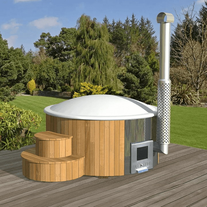 Closed InMedias Delux 200 Hot Tub with white dome cover, on a wooden deck in a landscaped garden under blue sky.