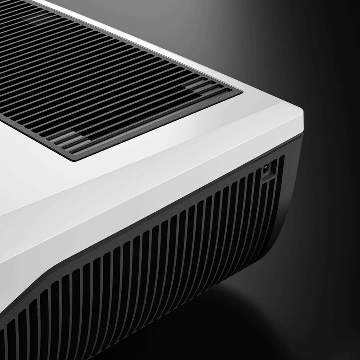 Dometic FreshJet FJZ4 1500 campervan air conditioner close-up of top vent design in white and black finish, with black background.