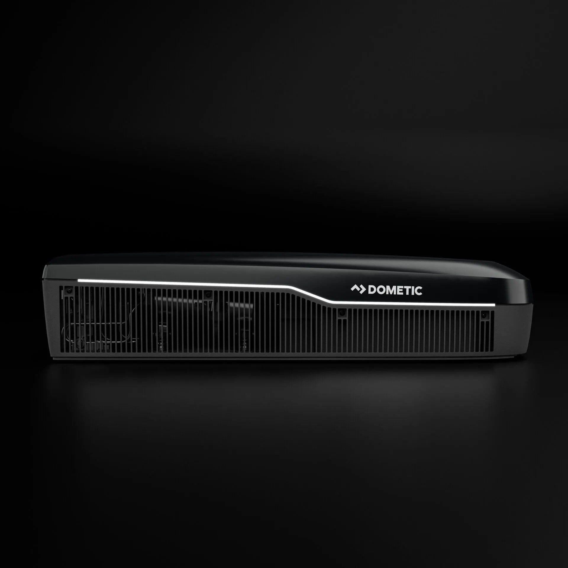 Dometic FJZ7 3000 black campervan roof air conditioner side view with grille detail, on a black background.