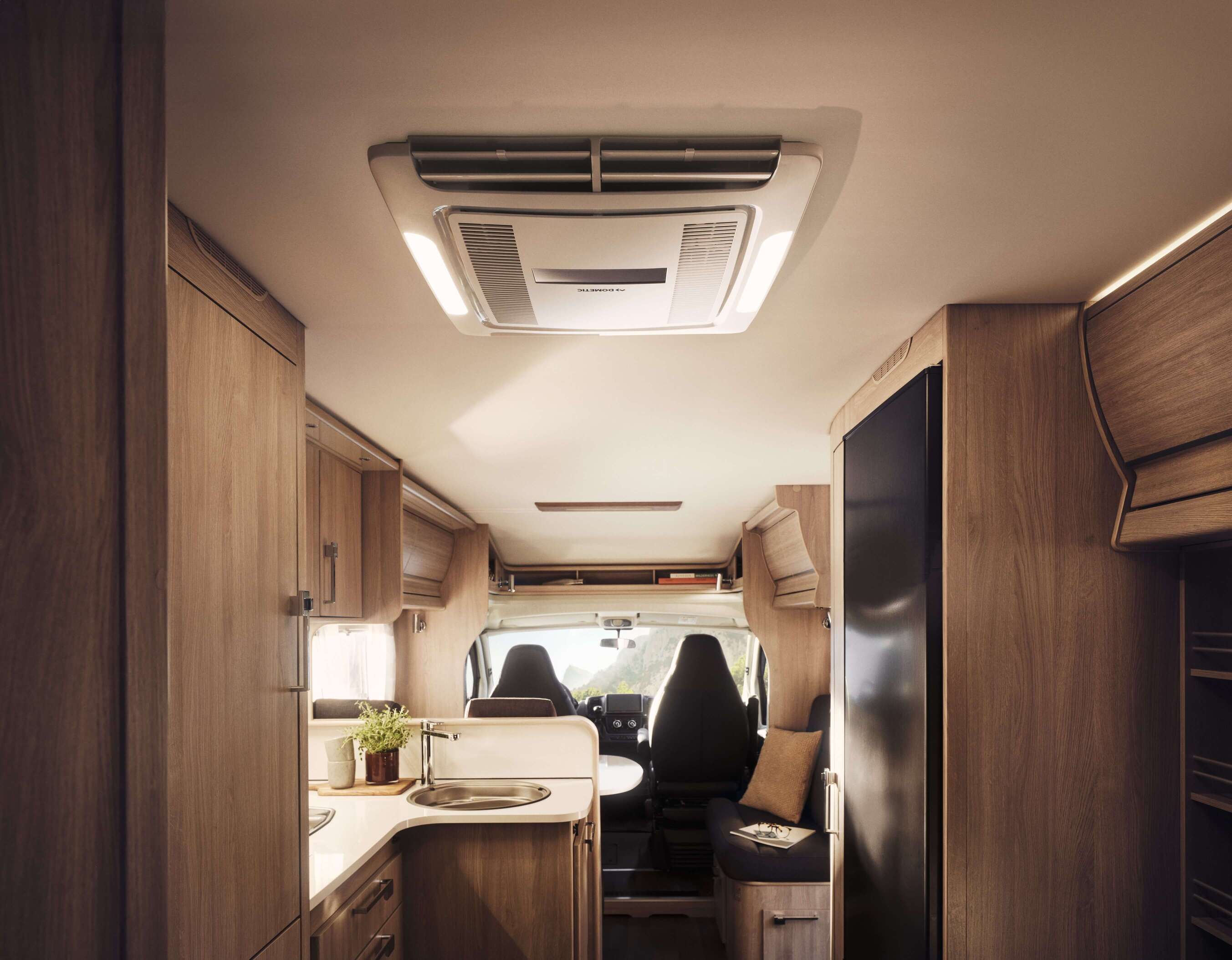 Dometic FJZ7 3500 roof mounted air conditioner installed inside campervan ceiling interior.