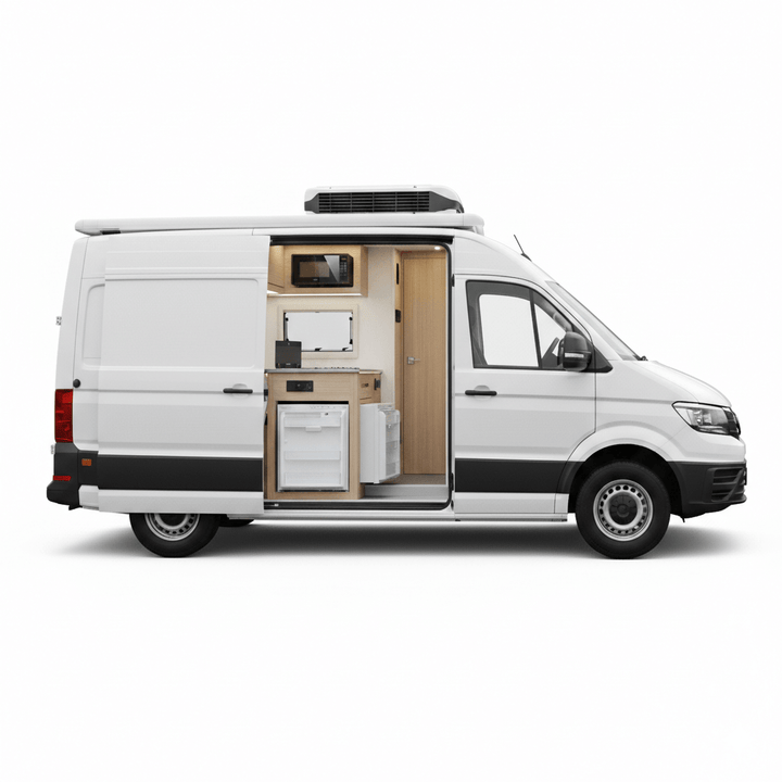 Dometic campervan appliance conversion kit installed in a VW Crafter showing a built in fridge microwave hob sink cabinets and roof mounted air conditioner in a modern wood finished campervan interior on a white background.