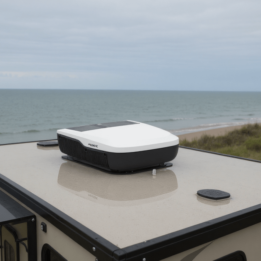 Dometic FreshJet FJX4 2200 rooftop air conditioner installed on an RV parked near the ocean.