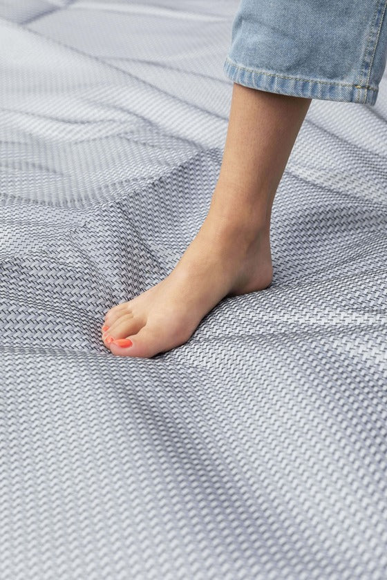 Bare foot standing on Dorema Starlon awning carpet laid.