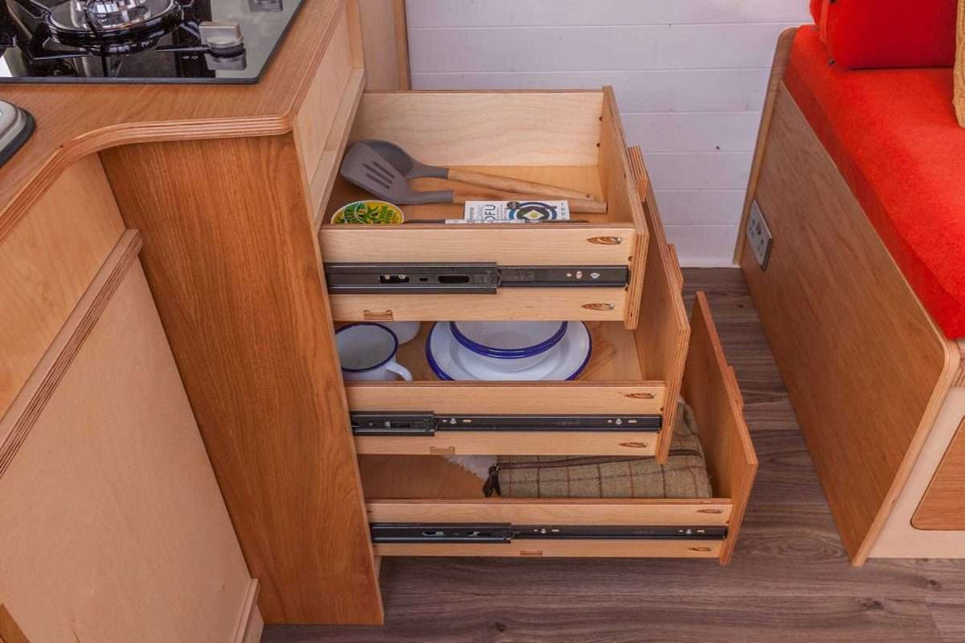 Interior storage view of the Campervan Foss Kitchen Unit showing multiple pull-out drawers for organised kitchen utensils and cookware.