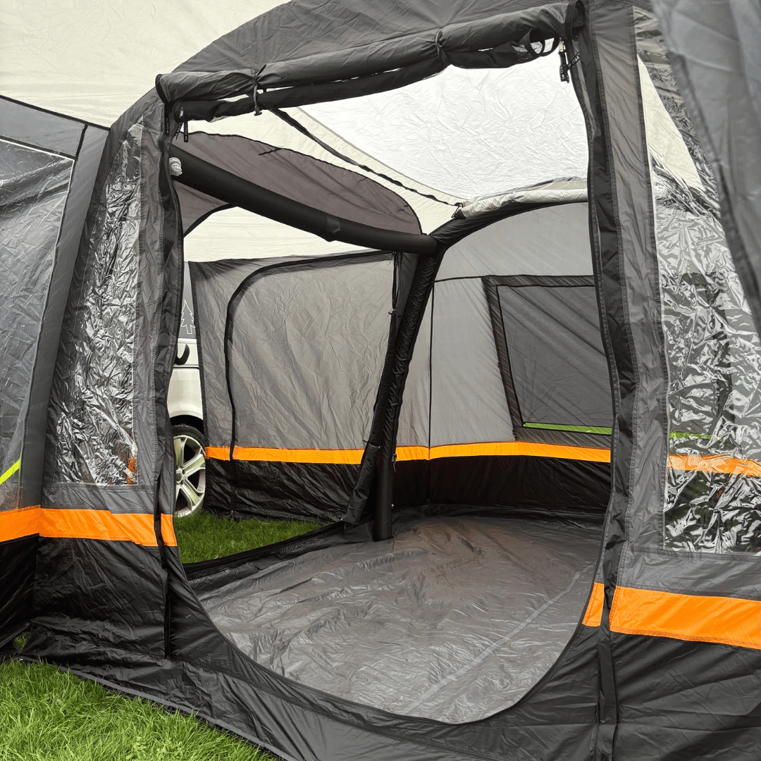 Interior view of the OLPRO Hanley Breeze inflatable awning with open panels on a grassy field.