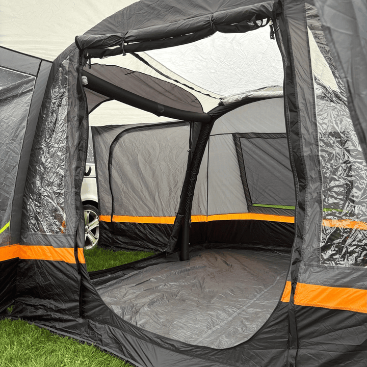 Interior view of the OLPRO Hanley Breeze inflatable awning with open panels on a grassy field.