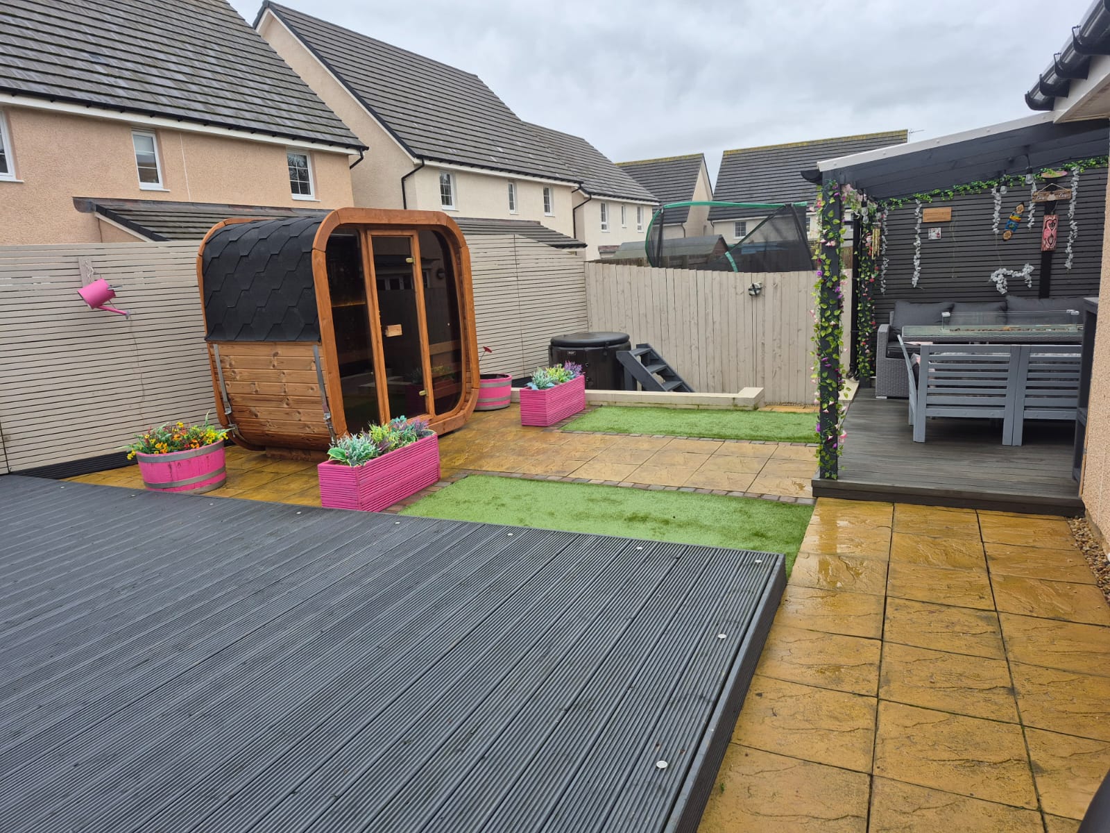 Backyard with an Icon 125 sauna, garden furniture, and outdoor decor.