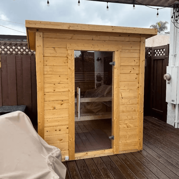 InMedias Brico Log Sauna installed outdoors on a wooden deck.