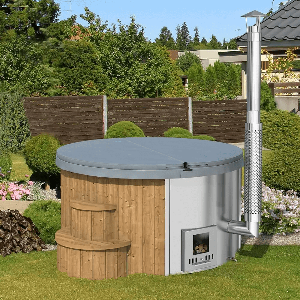 Closed InMedias Delux 200 Hot Tub with grey cover and chimney, placed on green grass in a backyard garden.