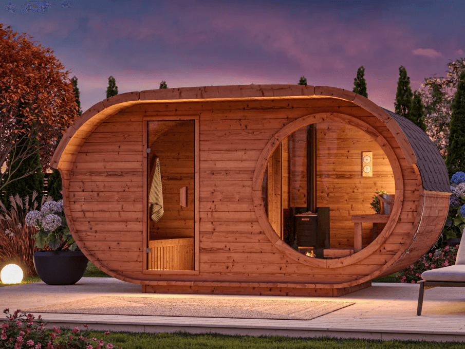 InMedias Raiki Oval Sauna in an outdoor garden setting at sunset.