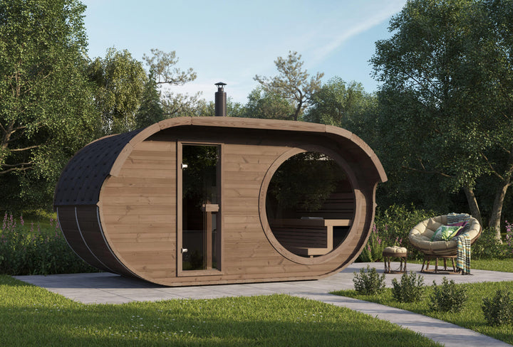 InMedias Raiki Oval Sauna in an outdoor garden setting  with side chair during daytime.