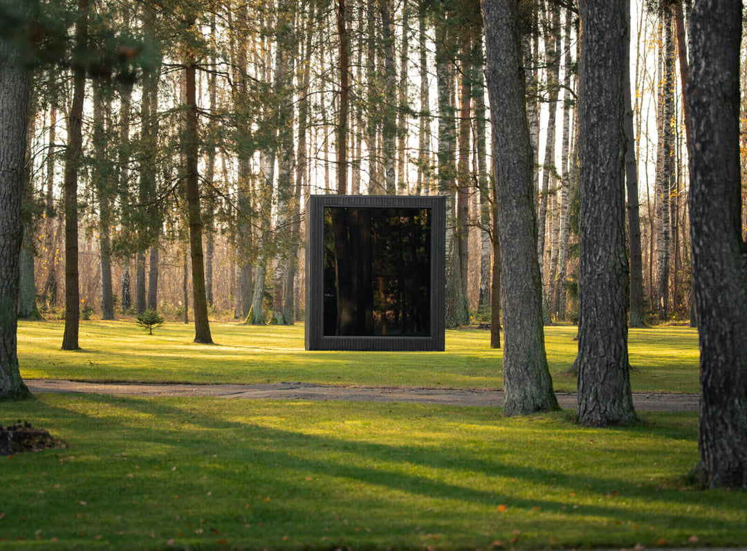 Jonas Classic Outdoor Sauna ebony finish front view, positioned in wooded landscape on grass