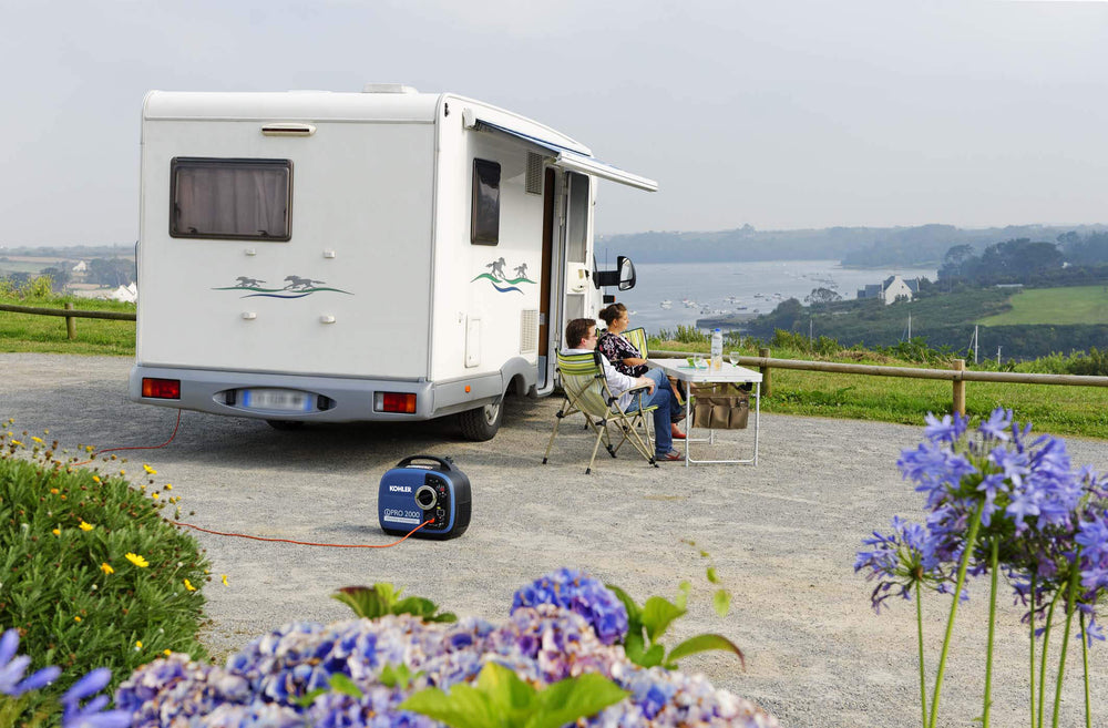 Kohler Inverter Pro 2000 UK C5 generator connected to a campervan at a scenic coastal campsite.