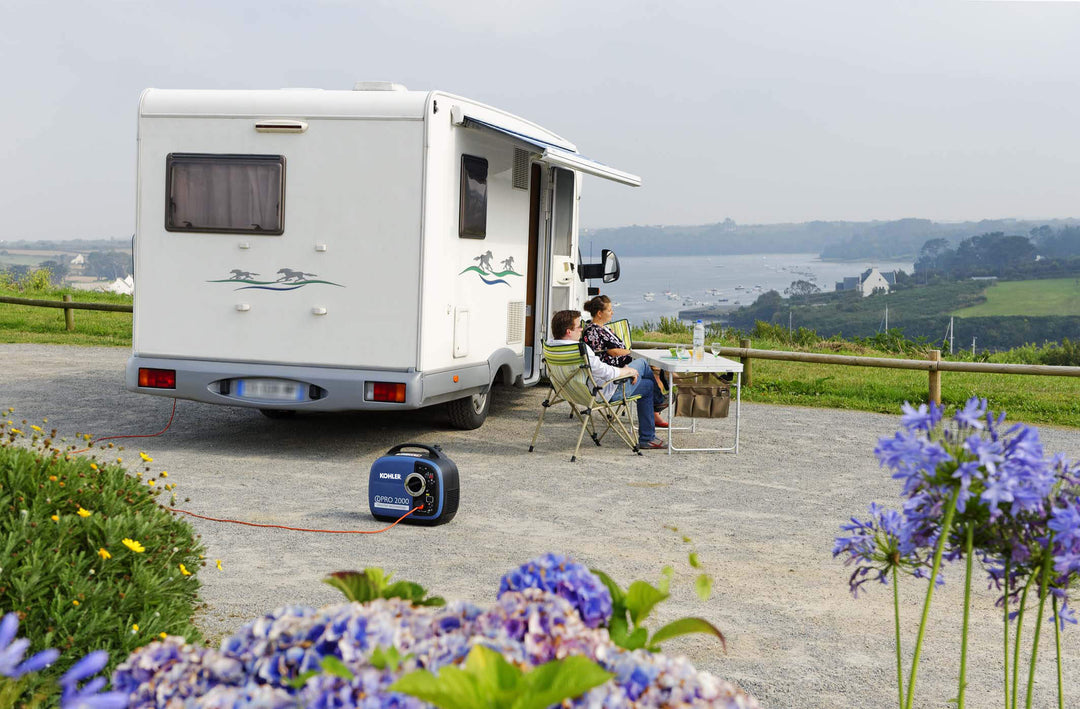 Kohler Inverter Pro 2000 UK C5 generator connected to a campervan at a scenic coastal campsite.