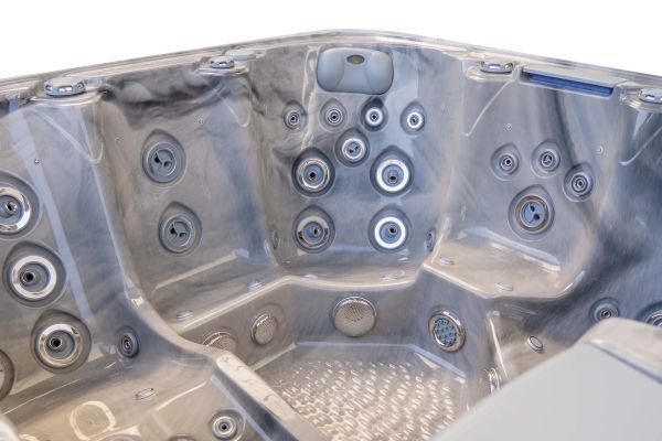 Interior of the Luso Spas The Platinum 5 Hot Tub in Odyssey Grey acrylic with jets and headrest, on a white background.