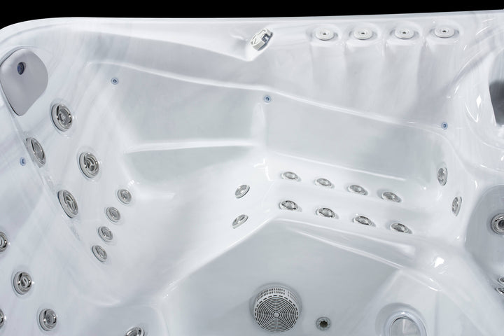 Close-up view of Luso Spas The 7000 Hot Tub interior in white showing massage jets and contoured seating.