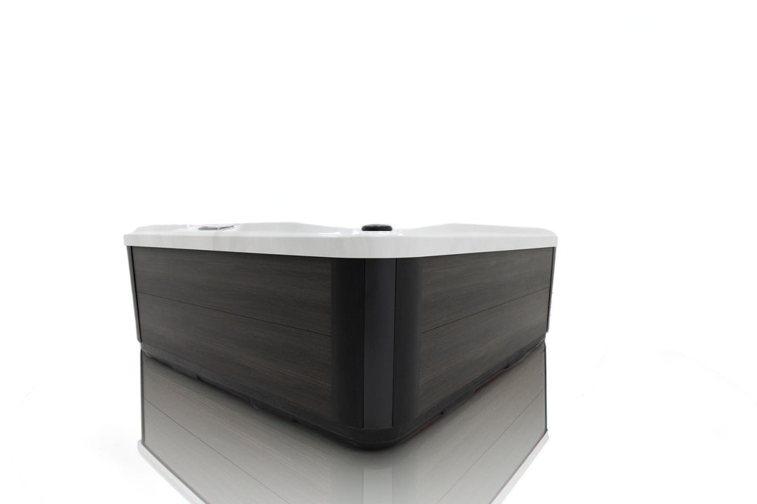 Side view of Luso Spas The Garda Hot Tub exterior showing modern dark wood-effect panel design on a white background.