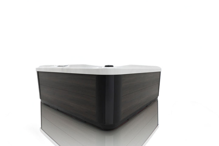Side view of Luso Spas The Garda Hot Tub exterior showing modern dark wood-effect panel design on a white background.