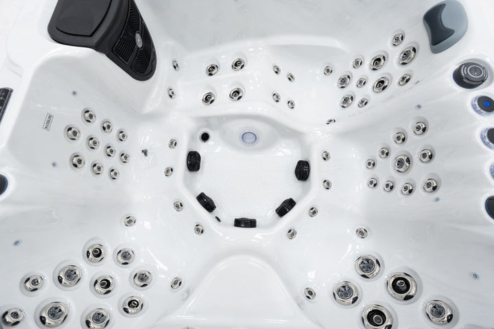 Detailed interior of Luso Spas The Garda Hot Tub featuring massage jets, controls, and textured base on a white background.