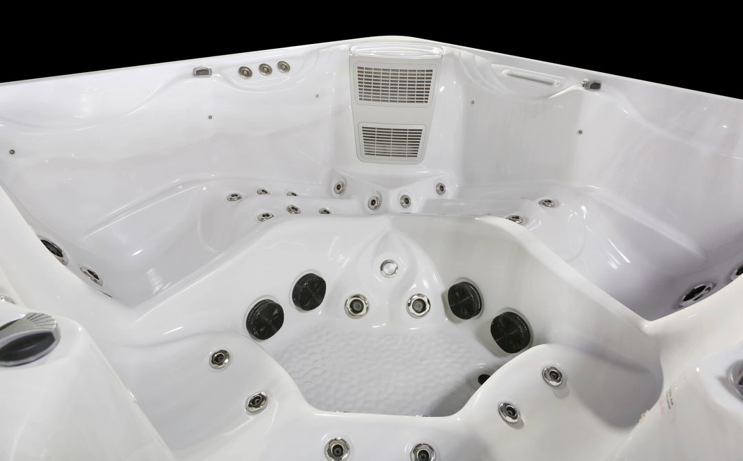 Luso Spas The Luna Hot Tub interior close-up with jets and seating on a black background.