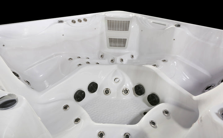 Luso Spas The Luna Hot Tub interior close-up with jets and seating on a black background.