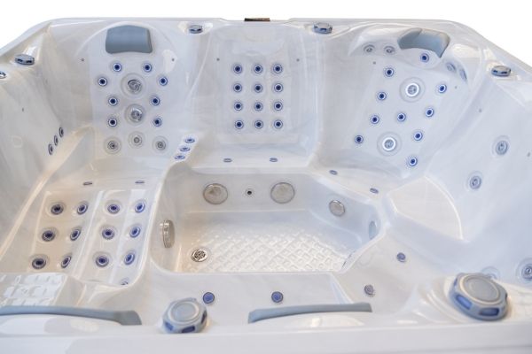 Angled view of the interior seating and jets of the Luso Spas The Maximus 2 Hot Tub in white, on a white background.