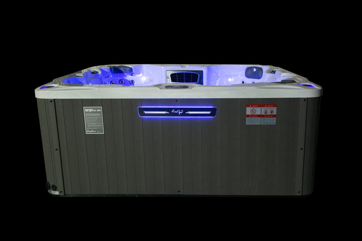 Front view of the Luso Spas Miami Hot Tub at night with LED lighting activated, on a black background.
