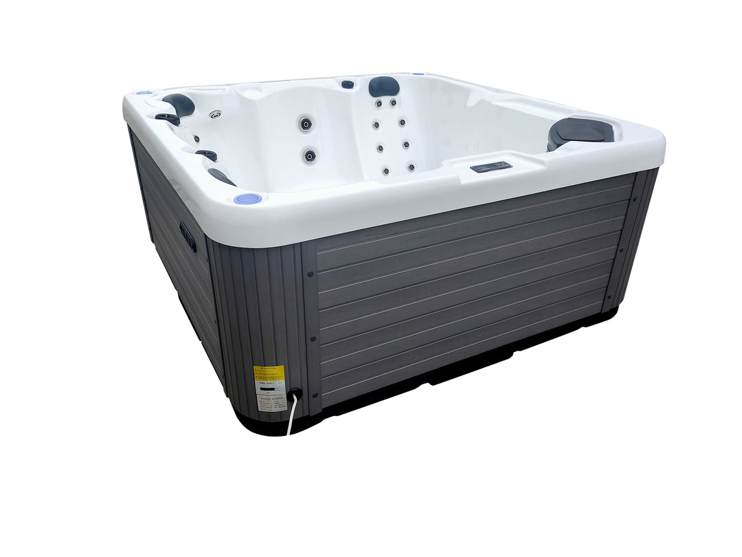 Angled view of Luso Spas The Opal Plug & Play Hot Tub filled with water showing bubbling hydrotherapy jets on a white background.