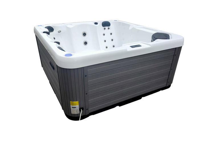 Angled view of Luso Spas The Opal Plug & Play Hot Tub filled with water showing bubbling hydrotherapy jets on a white background.