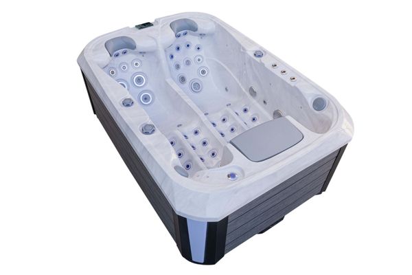 Top angled view of Luso Spas The Platinum 1 Hot Tub in white marble finish featuring dual loungers and multiple hydrotherapy jets, on a white background.