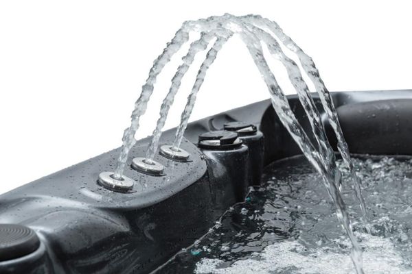 Water jets arching from hot tub edge into water on a white background.