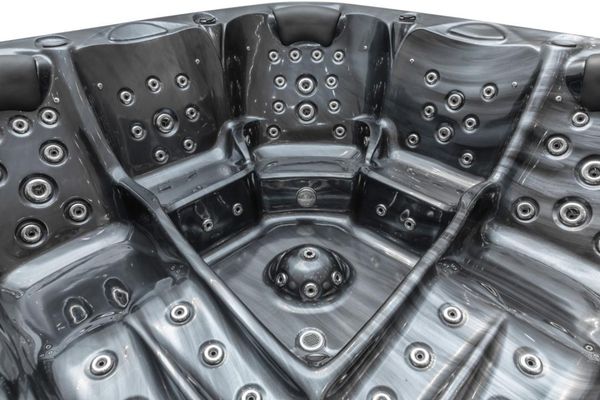 Wide view of the dark acrylic Luso Spas The Platinum 9 Hot Tub interior showing multiple seats and jet placements.