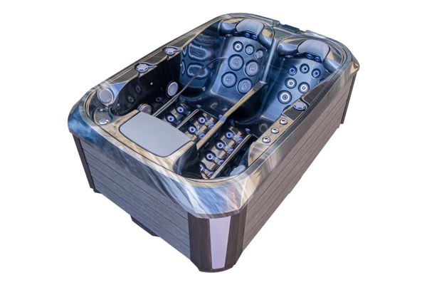 Angled side view of Luso Spas The Platinum 1 Hot Tub in dark marble finish with dual-lounger seats and integrated headrests, on a white background.