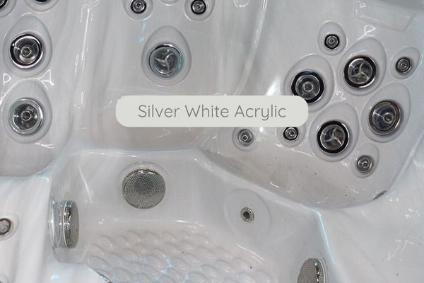 Close-up of silver white acrylic interior with hydrotherapy jets on a glossy white surface.