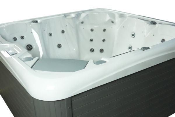 Angled side view of Luso Spas The Platinum 2 Hot Tub in white acrylic finish featuring contoured lounge seats on a white background.