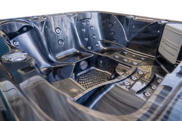 Close-up interior view of Luso Spas The Platinum 2 Hot Tub in black marble finish highlighting ergonomic seats and massage jets on a white background.